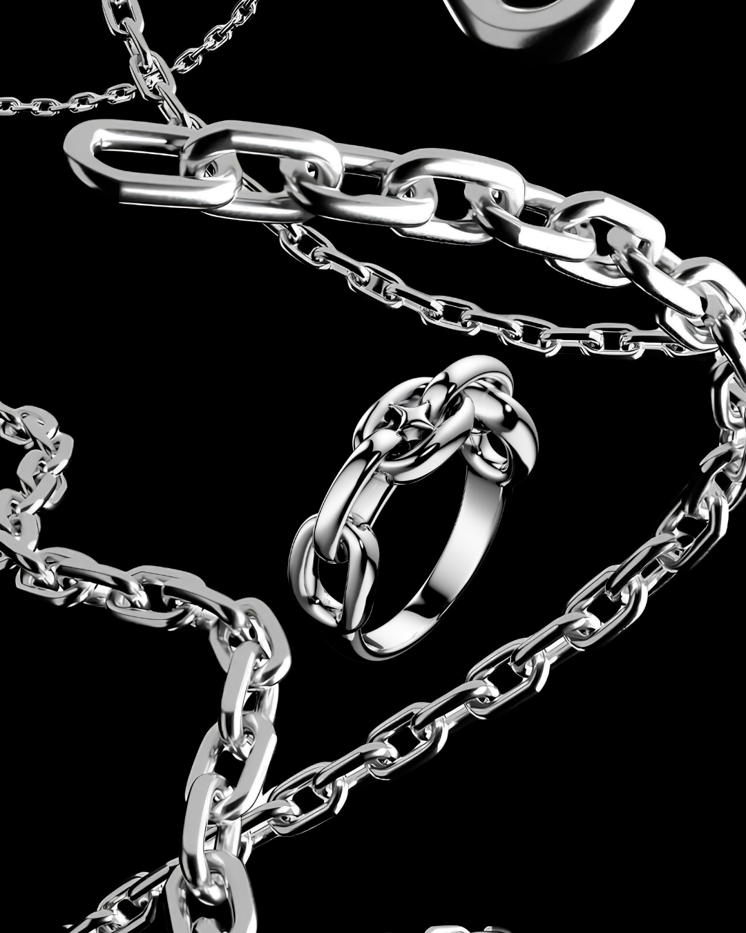 A close-up studio shot of a silver-toned chain necklace with chunky interlocking links, a matching ring, and a small oval charm, arranged on a black background.